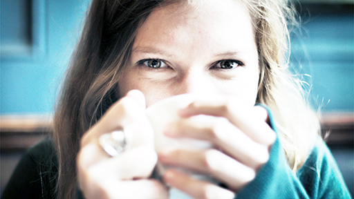 happy young woman drinking coffee