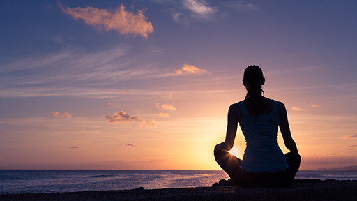 Woman relaxing and enjoying the beautiful sunset view